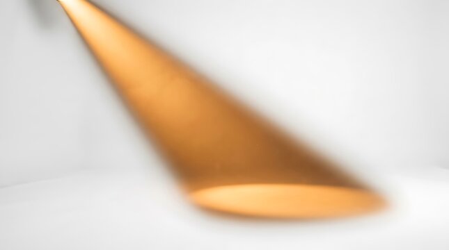 Blurred golden cone shaped object closeup.