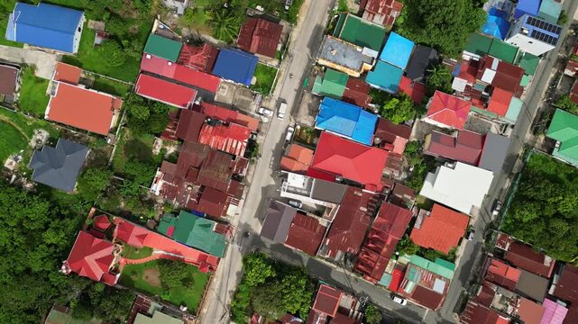 Wide angle aerial shot of CJDC Building and nearby roads in Poblacion III Alfonso Cavite Philippines featuring roadside businesses and a provincial town setting.