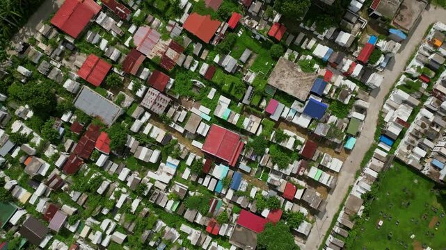 Pullback drone reveal of Alfonso Public Cemetery in Cavite Philippines showcasing the full grounds and its position within the surrounding provincial landscape.