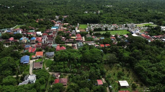 Top view aerial shot of the Alfonso Indang Road area in Alfonso Cavite Philippines revealing the road layout, residential lots, and clusters of houses surrounded by trees.