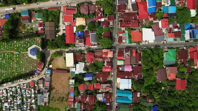 Wide establishing drone footage of CJDC Building in Alfonso Cavite Philippines with visible roadside activity, nearby commercial spaces, and provincial town infrastructure.