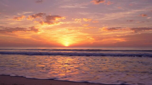 Golden hour sunset over tropical ocean waves, serene beach seascape with vibrant orange and purple sky, relaxing coastal nature background