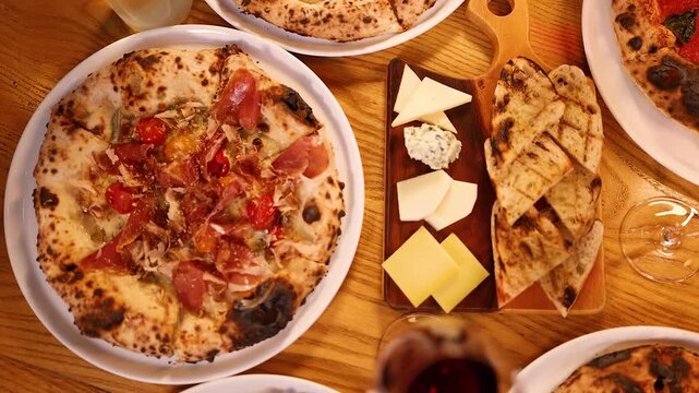 Overhead View of Italian Feast with Neapolitan Pizza and Antipasto