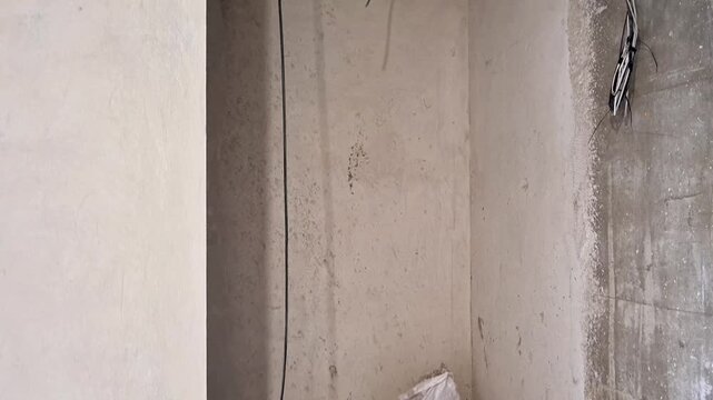 An exposed concrete ceiling with visible electrical wiring during an interior renovation. Construction work highlights unfinished infrastructure, modern building systems, and remodeling progress