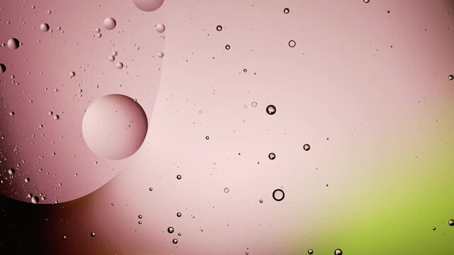 Abstract macro sequence of oil droplets drifting against pastel gradient