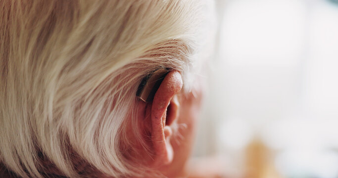 Elderly, person and hearing aid with space in home, auditory support and help in retirement. Deaf, ear or cochlear implant for pensioner with disability, healthcare and technology in senior housing
