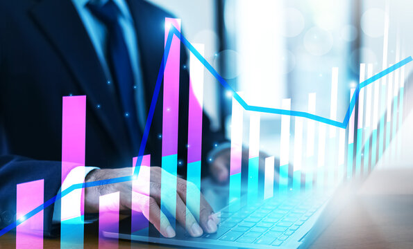 Businessman analyzing investment charts and financial data during periods of high market volatility to make informed decisions