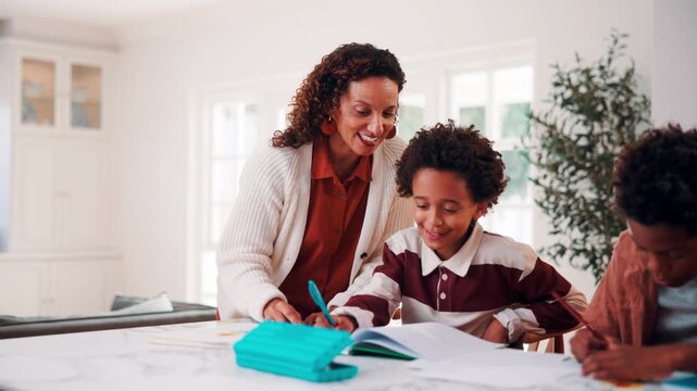 Education, mother and son writing in home for child development, homework help or learning. Notebook, smile and study with African family at counter in apartment for assistance or school assignment