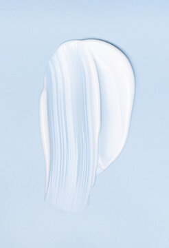 cosmetic smears cream texture on pastel blue background