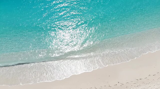 Aerial overhead shot of tropical beach with shimmering water surface during a bright summer heatwave