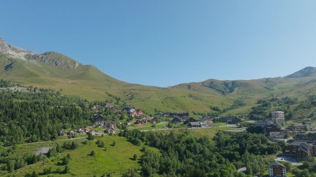 Cinematic aerial drone footage of the French Alps showcasing breathtaking mountain landscapes, dramatic peaks, lush green valleys, dense forests, and pristine alpine nature. Stunning panoramic views c