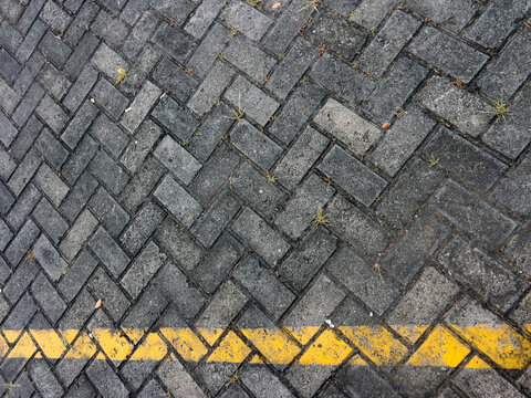 A detailed view of a concrete paving block floor featuring durable interlocking pavers with a clean geometric pattern. Ideal for construction, architecture, landscaping, urban design, driveways, walkw