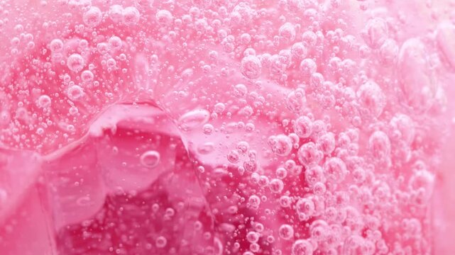 Pink serum gel background, cream, shampoo, macro soap bubbles, foam texture