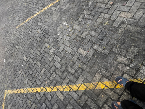 A detailed view of a concrete paving block floor featuring durable interlocking pavers with a clean geometric pattern. Ideal for construction, architecture, landscaping, urban design, driveways, walkw