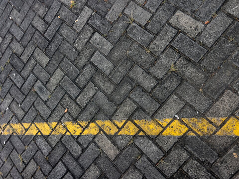 A detailed view of a concrete paving block floor featuring durable interlocking pavers with a clean geometric pattern. Ideal for construction, architecture, landscaping, urban design, driveways, walkw