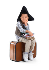 Obraz premium Cute little pirate with adventure book on white background