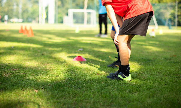 Junior soccer players practicing outside on a bright sunny day. Active lifestyle for kids.
