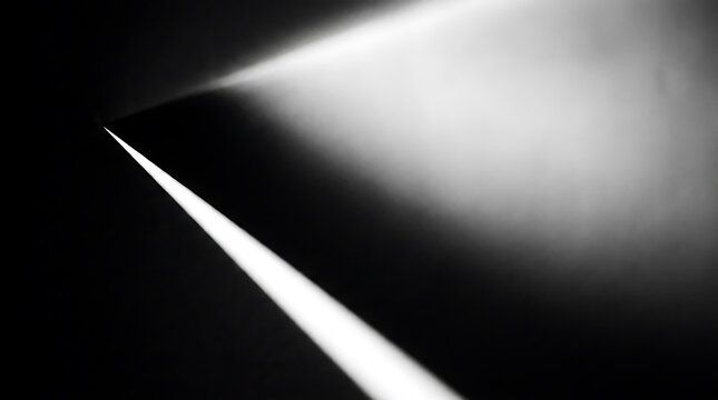 Bright white spotlight beam shining in dark black background