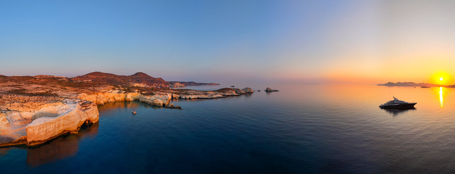   
Golden sunrise over the white cliffs and calm Aegean Sea near Mandrakia on Milos Island, capturing peaceful light, soft reflections, and the quiet beauty of the Cyclades at dawn.