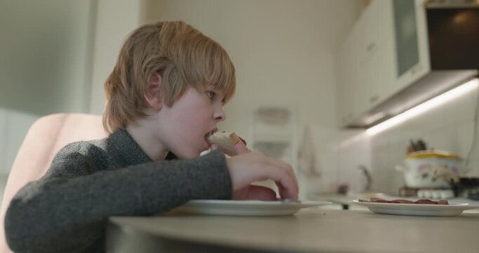 Kid Boy Eat Rice and Sausage. Eating Breakfast Lunch in Kitchen. 4K 10-bit