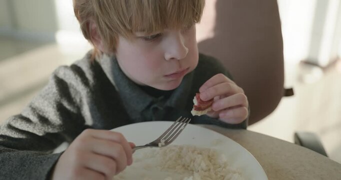 Kid Boy Eat Rice and Sausage. Eating Breakfast Lunch in Kitchen. 4K 10-bit