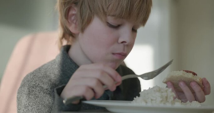 Kid Boy Eat Rice and Sausage. Eating Breakfast Lunch in Kitchen. 4K 10-bit