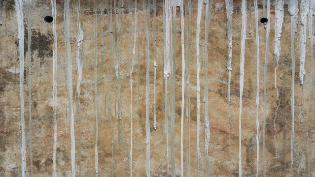 melt drip cement liquid on concrete wall, grunge rough weathered rustic texture, construction exterior background	

