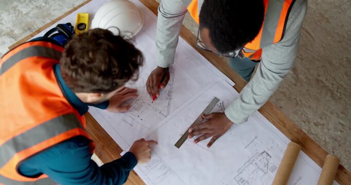 Architecture, team and men with blueprint for planning, design update and ruler for accuracy. Above, people and floorplan at worksite for engineering, explain infrastructure and compliance sketch