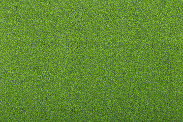 Artificial soccer turf texture with dense green synthetic grass blades in close up view. Sports background for soccer field, training ground, playground, and outdoor design. © natrot