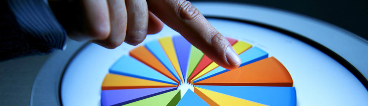 A professional setting where a financial advisor points at a chart showing various asset allocation models on a large screen. The composition is clean, with enough copy space for text.