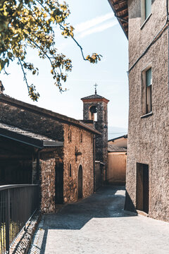 view of the town of tignale, ancient church and blossoms at spring time