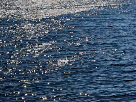 Ocean glittering blue water surface. 
