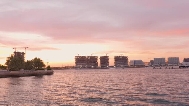 Yas island and Modern Waterfront Architecture at Al Raha Beach, Abu Dhabi During Sunset