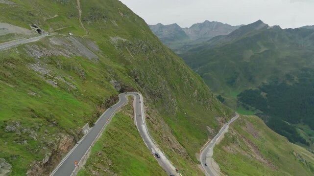 Aerial view of the High Alpine Road, Austria. Cars drive along a winding road in the mountainous Tyrol region; travel and tourism in Europe.
