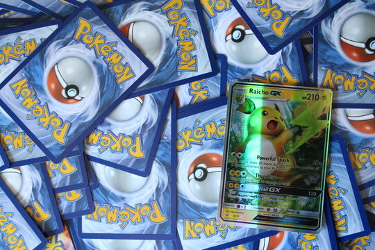 Raichu Pikachu Pok&eacute;mon trading card displayed on a background of Pok&eacute;mon cards. Editorial image illustrating the global trading card market, collectibles industry, gaming business and consumer trends.