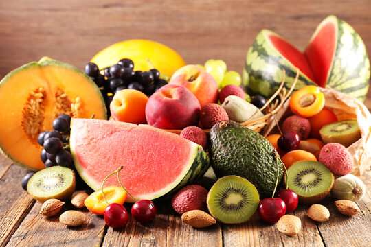 Close up of colorful assortment of fresh summer fruits on wooden background
