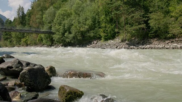Crystal clear waters of the Otztaler Ache River flowing through the Austrian Alps with breathtaking mountain scenery and travel destinations