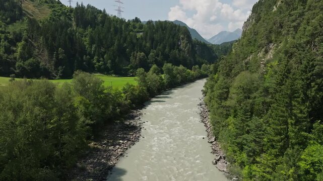 Scenic aerial view of the Otztaler Ache River winding through mountain valleys and forests in the Austrian Alps travel destination in Europe