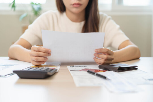 person using calculator calculating tax refund on the table