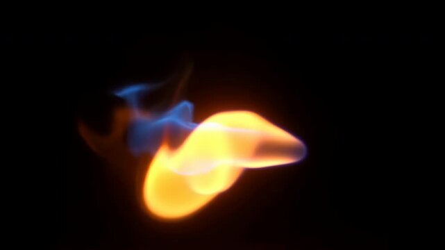 Isolated orange and blue flame shifting against black background, bright core leaning sideways while cool wisps curl, trail, and glow with vivid contrast, with flame, fire, orange, blue detail