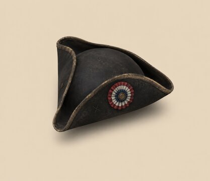 Antique black tricorn hat featuring a circular french cockade emblem isolated on a neutral beige background