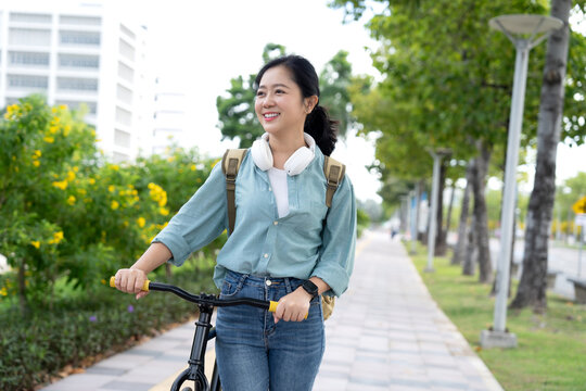 Asian women happily walk and cycle in parks and on city streets.