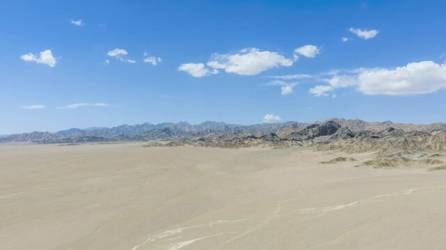 Aerial Time-Lapse of Vast Gobi Desert Plain with Mountain Range in Northwest China  