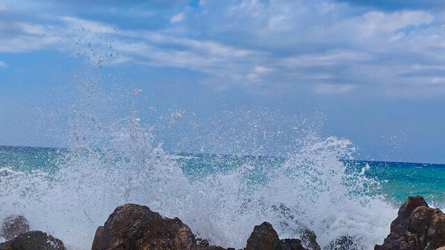 waves crashing on rocks. Place for text.