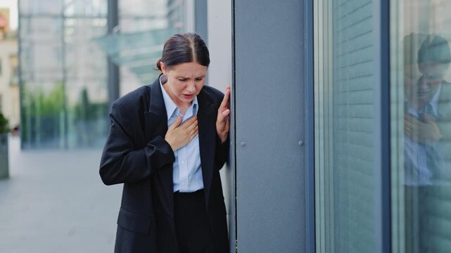 Professional experiences sudden chest pain and distress. Symptoms indicate potential heart issue or severe anxiety, highlighting vulnerability and urgent health concern in corporate environment.
