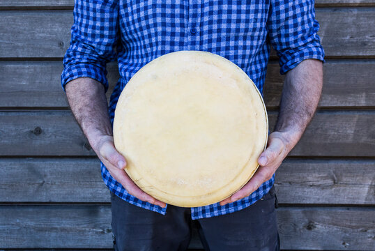 Hand of a man holding a cheese