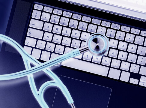 Overhead view of stethoscope on laptop