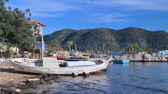 Wooden fishing boat resting on a rocky beach in Kekova, Turkey