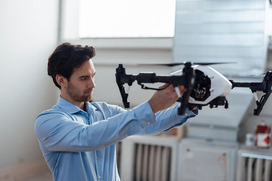 Engineer examining drone at industry