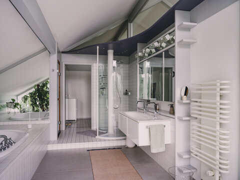Spacious white 90s bathroom interior with bathtub and shower